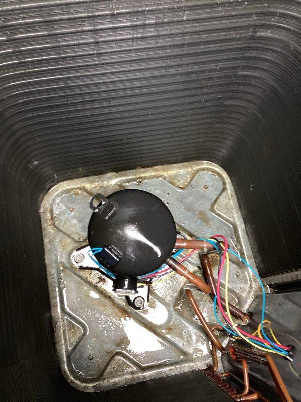 Performed routine air conditioning maintenance on outdoor condensing unit. Inspected compressor, refrigerant lines, and electrical connections inside unit compartment—all components found operating within normal parameters. Cleaned condenser coils to remove dirt and debris accumulation from exterior fins. Completed factory reset of thermostat per customer request to restore default settings.