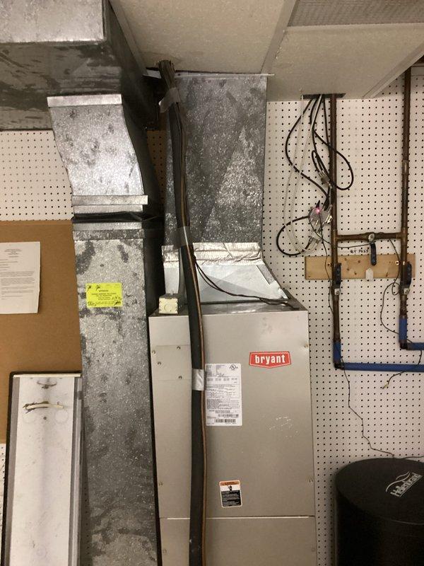 Conducted on-site evaluation for complete HVAC system replacement estimate. Assessed existing outdoor condensing unit showing significant age and deterioration with heavy soiling on exterior panels, and indoor Bryant furnace/air handler with associated ductwork in mechanical room. Documented current equipment condition through photographs to determine feasibility of replacement installation given existing location constraints, electrical service configuration with dual meters, and accessible concrete pad positioning for outdoor unit.