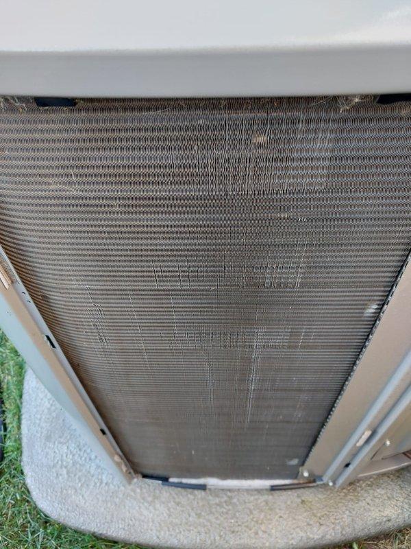 Completed scheduled AC maintenance on residential air conditioning system. Performed comprehensive inspection of outdoor condenser unit, noting moderate dust and debris accumulation between evaporator coil fins. Inspected indoor air handler components including copper refrigerant lines, drain pan, and coil assembly. Drain pan showed normal water presence with minor mineral deposits consistent with regular operation. All refrigerant lines and connections were visually inspected and found secure with typical oxidation patina. System components operational and functioning within normal parameters.