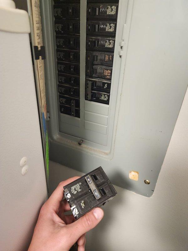 Conducted warranty inspection and documented multiple code violations requiring correction before final approval. Identified oversized 40-amp breaker installed where maximum 25-amp fuse required, non-fuse disconnect present instead of required fused disconnect, and improper SO cord rated below required 105° temperature entering furnace. Documented unauthorized SO cord penetration from furnace into ductwork without proper bushing protection, control wiring improperly routed across top of furnace cabinet, and single-wall flue vent connector positioned within 6 inches of electrical wiring creating potential fire hazard. Photographed electrical panel showing breaker configuration and captured images of all identified deficiencies for contractor review and correction prior to re-inspection.
