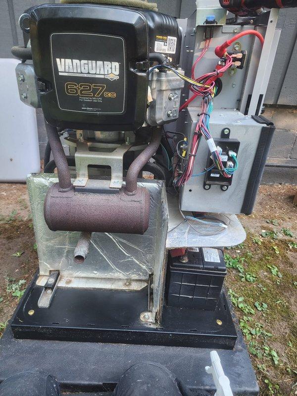 Performed scheduled maintenance on Vanguard 627cc generator unit. Removed and replaced both spark plugs, inspected engine cooling system and fan assembly, and verified electrical connections and wiring harnesses. Observed weathering and oxidation on mounting brackets and external components consistent with outdoor installation. Battery connections checked and found secure. Unit tested and returned to service.