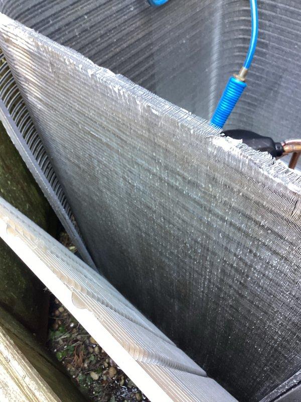 Responded to service call for non-operational AC unit with fan failure on system installed in January 2025. Upon inspection, found condenser coil heavily clogged with dirt, dust, and debris causing restricted airflow and preventing proper system operation. Performed thorough coil cleaning using pressurized water to remove accumulated contaminants from aluminum fins and restore airflow capacity. Verified refrigerant line connections, electrical wiring, and mounting hardware were secure and properly installed. System tested and confirmed operational following cleaning procedure.