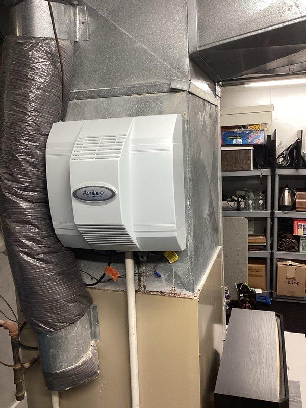 Conducted comprehensive assessment of residential HVAC system for proactive replacement estimate. Current furnace and air conditioning equipment is approximately 30 years old but still operational. Evaluated existing installation including ductwork configuration with Aprilaire whole-house humidifier integration, assessed mechanical room layout and clearances, and documented system specifications. Photographed current equipment setup to provide detailed visual reference for replacement proposal. Homeowner requesting estimate for complete furnace and AC replacement before system failure occurs.