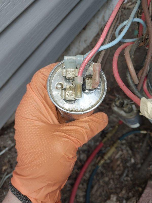 Responded to no cooling call on 25-year-old air conditioning system located on south side of residence. Upon arrival, performed diagnostic evaluation of outdoor condensing unit. Identified failed dual run capacitor as primary cause of system failure. Capacitor showed visible signs of deterioration, age-related wear, and complete loss of capacitance. Removed defective capacitor and installed new replacement unit with proper microfarad rating for compressor and condenser fan motor. Verified all electrical connections were secure at capacitor terminals and contactor. Restored power to system and confirmed compressor and outdoor fan motor started properly. Monitored system operation through complete cooling cycle. Verified proper amperage draw on compressor and fan motor. Confirmed cold air delivery at indoor registers and proper temperature split across evaporator coil. System restored to full operational status. Given the advanced age of the equipment, advised customer that additional co