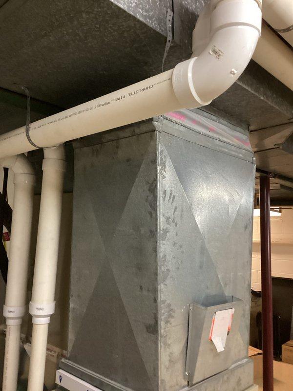 Completed full system replacement estimate for residential HVAC equipment located in basement mechanical room. Assessed existing aging furnace unit and associated ductwork, noting surface wear and current installation configuration with white PVC drainage piping and metallic ventilation ductwork. Customer elected to proceed with complete system replacement rather than repair existing equipment.