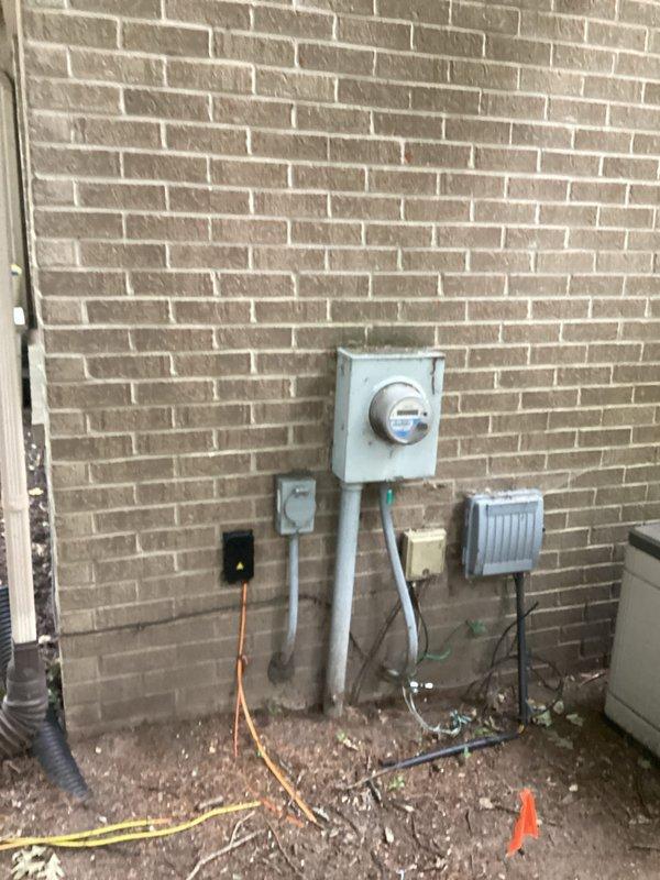 Conducted comprehensive site assessment for generator installation estimate at residential property. Documented existing electrical infrastructure including main service panel with digital control unit and dual-row breaker configuration, exterior meter assembly with associated disconnect equipment, and current utility connections. Photographed electrical system components, conduit routing pathways, and available installation locations to develop accurate generator integration proposal and determine required materials for proper transfer switch installation and code-compliant electrical connections.