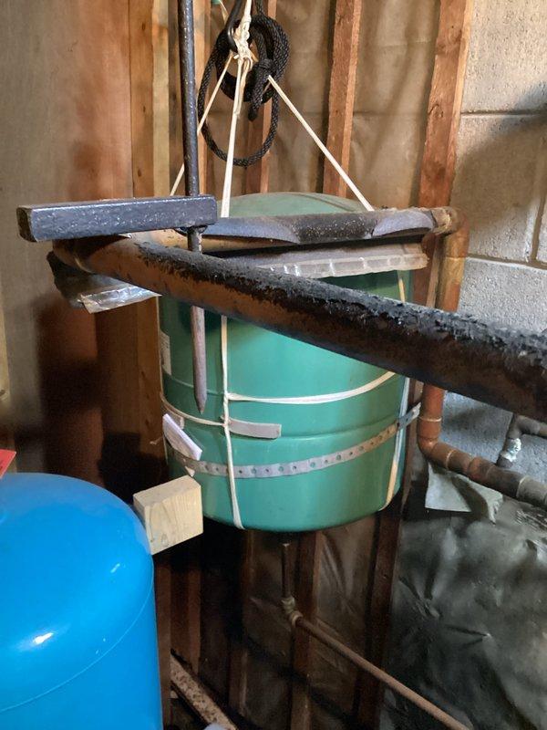 Provided estimate for replacement of 40-year-old boiler system currently operating on natural gas in basement utility area. Assessed existing mechanical infrastructure including aged copper piping showing significant corrosion, natural gas supply lines, and current boiler configuration within unfinished basement space with exposed framing and insulation. Documented equipment condition and surrounding utility connections to prepare comprehensive replacement proposal for aging heating system.