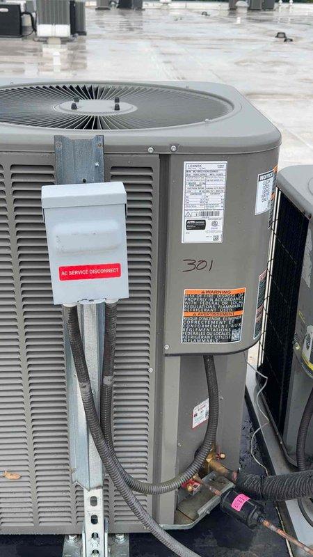 Completed warranty inspection on rooftop AC unit #301. Corrected electrical code violation by replacing oversized 40-amp breaker with properly rated breaker to match unit's 25-30 amp maximum specification. Added required condenser identification label per MMC 304.12 compliance requirements and documented installation with photographs.