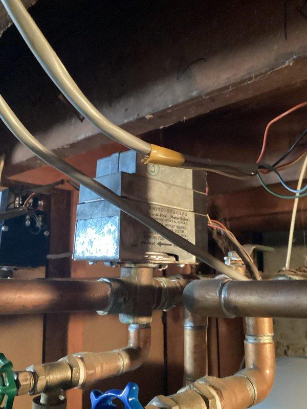 Conducted comprehensive boiler system evaluation for 30-year-old unit experiencing active leaks. Documented existing mechanical room configuration including interconnected heating and plumbing infrastructure, assessed copper piping network showing age-related deterioration, and photographed current equipment conditions to support replacement recommendations due to system age and compromised integrity.