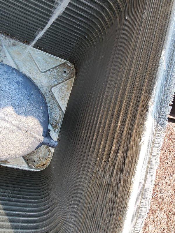 Performed comprehensive cooling season maintenance on outdoor condensing unit per Worry Free Service Agreement. Inspected heat exchanger coils, which showed significant accumulation of dirt and debris with visible discoloration across fin surfaces. Accessed compressor compartment, evaluated electrical connections and refrigerant lines, and assessed overall system operation. Unit demonstrated weathering consistent with extended outdoor exposure, requiring attention to maintain optimal heat transfer efficiency and system performance.