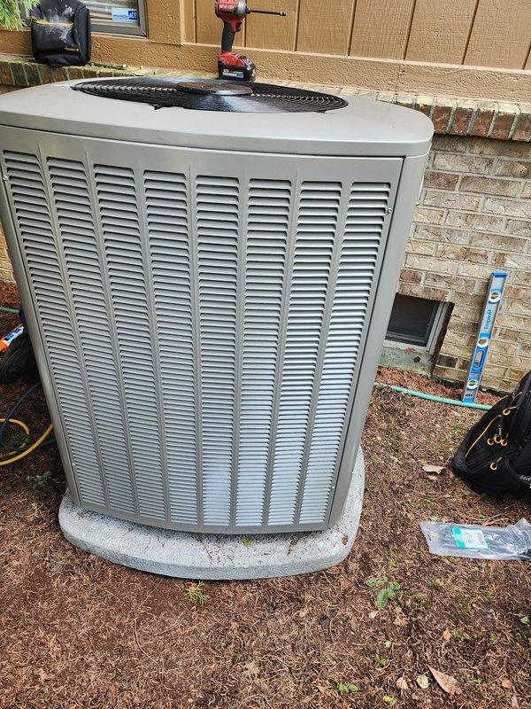 Completed full HVAC system installation including Lennox furnace, air conditioning unit, and S40 smart thermostat. The indoor air handler was positioned in the mechanical room with new supply and return ductwork connections, refrigerant line sets, condensate drainage, and electrical wiring properly installed and secured. The outdoor condensing unit was set on a concrete pad against the exterior brick wall with appropriate clearances, connected to power supply, and refrigerant lines run through the wall penetration. All components were tested for proper operation, system charged to manufacturer specifications, and thermostat programmed and synced with equipment.