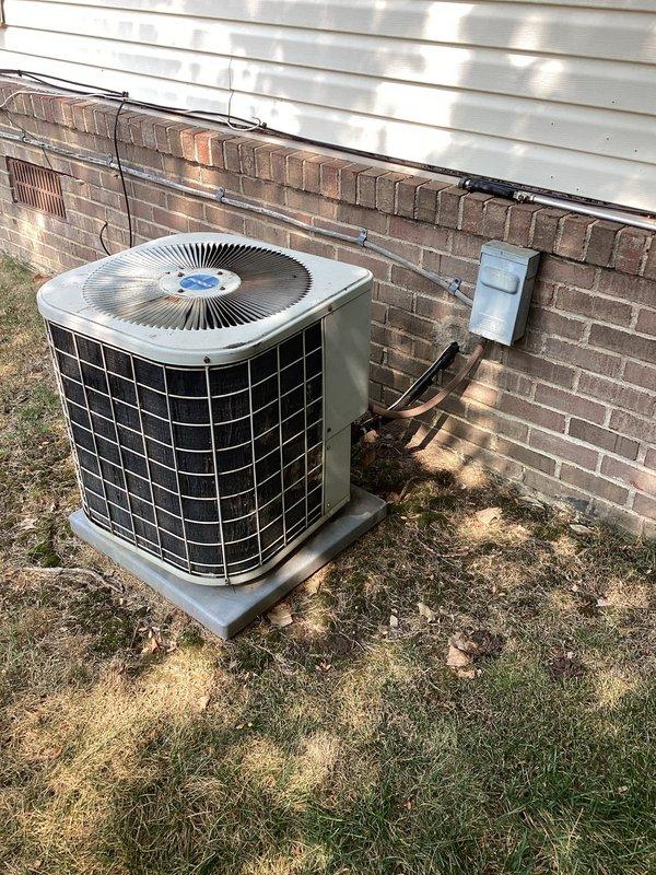 Conducted comprehensive on-site evaluation for complete HVAC system replacement. Assessed existing outdoor condensing unit and indoor electrical service panel, documented current equipment specifications, refrigerant line routing, and electrical disconnect configuration. Photographed all relevant components including breaker panel layout with circuit directory, existing condenser unit with copper line set penetration point, and concrete pad placement to provide detailed replacement estimate and system design recommendations.