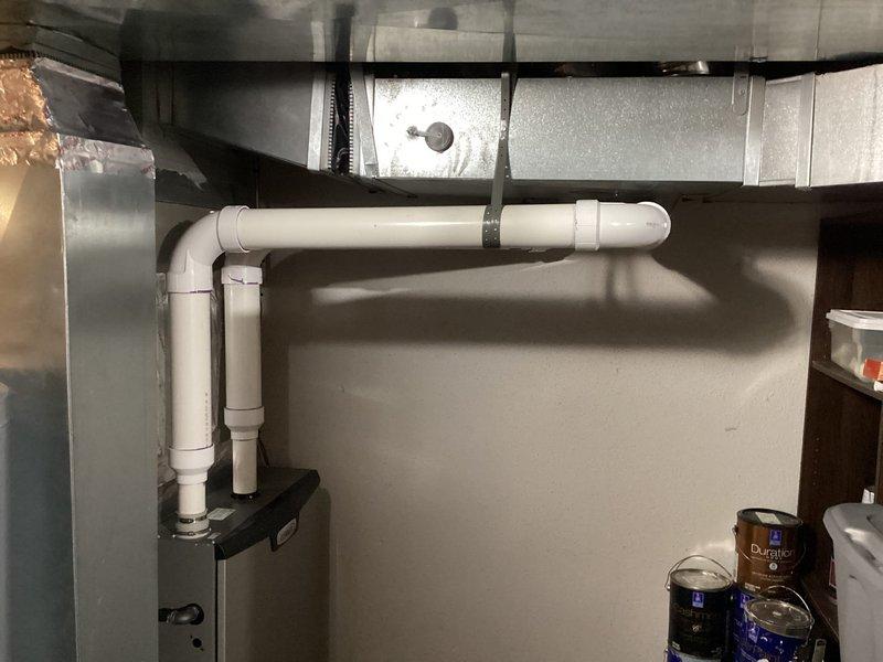 Completed full Lennox furnace installation with S40 thermostat programming and setup. Rotated furnace for proper orientation and reconfigured PVC venting system to run tight against wall and ductwork per specifications. Installed dual-pipe venting configuration with proper terminations. Reinstalled humidifier unit that had become dislodged during initial installation. Corrected filter size from 20x25x1 to proper 20x24x1 specification to ensure correct fit in filter drop. All system components tested and verified operational.