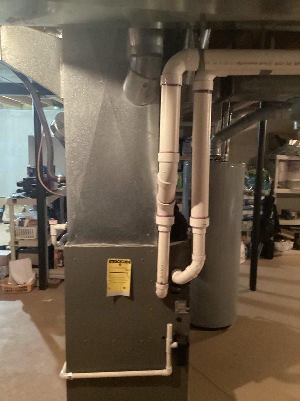 Completed comprehensive estimate for residential HVAC system replacement in basement utility room. Evaluated existing furnace/air handler unit with connected hot water heater, assessed current ductwork configuration including overhead metallic ducting and insulated refrigerant lines, and inspected PVC condensate drainage system with proper trap installation. Documented equipment specifications, spatial requirements, and existing infrastructure to provide accurate replacement system recommendations.