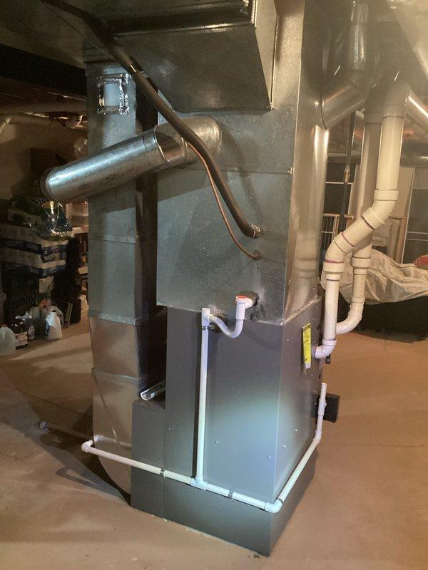 Completed comprehensive estimate for residential HVAC system replacement in basement utility room. Evaluated existing furnace/air handler unit with connected hot water heater, assessed current ductwork configuration including overhead metallic ducting and insulated refrigerant lines, and inspected PVC condensate drainage system with proper trap installation. Documented equipment specifications, spatial requirements, and existing infrastructure to provide accurate replacement system recommendations.