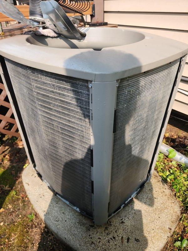 Completed routine cooling season maintenance on residential split system air conditioning unit and hot water tank inspection. Performed comprehensive maintenance on outdoor condenser unit including coil inspection, electrical connection verification, and operational testing. Inspected indoor evaporator coil assembly, compressor unit, refrigerant lines, condensate drain pan for proper drainage and potential overflow issues, and verified all electrical connections secure. All components found operating within normal parameters with no immediate service needs identified.