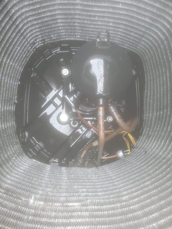 Completed preventive maintenance inspection on residential cooling system under Worry Free Service Agreement. Inspected evaporator coil assembly, verified proper refrigerant line connections, and examined blower compartment with motor assembly. All components found to be operating within normal parameters with copper refrigerant lines and electrical connections secure.