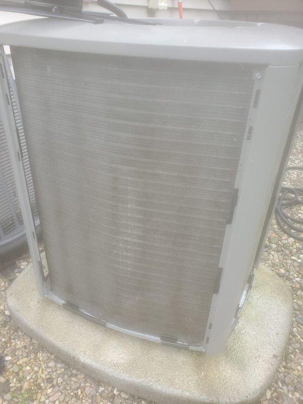 Completed scheduled air conditioning maintenance under Worry Free Service Agreement. Performed comprehensive inspection of outdoor condenser unit, noting dust and debris accumulation on coil fins. Cleaned condenser coils to restore proper airflow and heat transfer efficiency. Verified unit operational status and proper mounting on concrete pad. System operating within normal parameters following maintenance procedures.