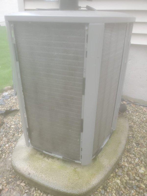 Completed scheduled air conditioning maintenance under Worry Free Service Agreement. Performed comprehensive inspection of outdoor condenser unit, noting dust and debris accumulation on coil fins. Cleaned condenser coils to restore proper airflow and heat transfer efficiency. Verified unit operational status and proper mounting on concrete pad. System operating within normal parameters following maintenance procedures.