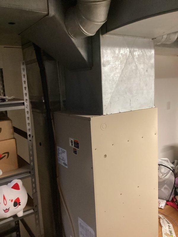 Completed on-site evaluation for complete HVAC system replacement in residential property. Assessed existing air handler unit located in basement utility area and documented current installation configuration, including ductwork connections, plenum assembly, and spatial constraints. Photographed interior air handler component positioned in finished living space to evaluate accessibility requirements and determine proper equipment sizing for replacement system. Provided comprehensive estimate for new air handler and air conditioning system installation based on existing infrastructure and homeowner scheduling requirements.