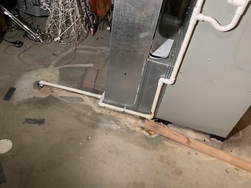 Completed installation of new Bryant air conditioning system at residential property. Connected refrigerant lines, electrical supply, and integrated unit with existing ductwork in basement utility area. System tested and operational, ready for cooling season.