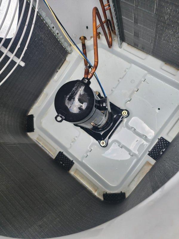 Completed comprehensive cooling season maintenance inspection on residential split system air conditioning unit. Serviced outdoor condenser unit with protective grille guard and inspected indoor air handler components including condensate management system with pump assembly and drain pan. All equipment operating within normal parameters with proper drainage function confirmed.