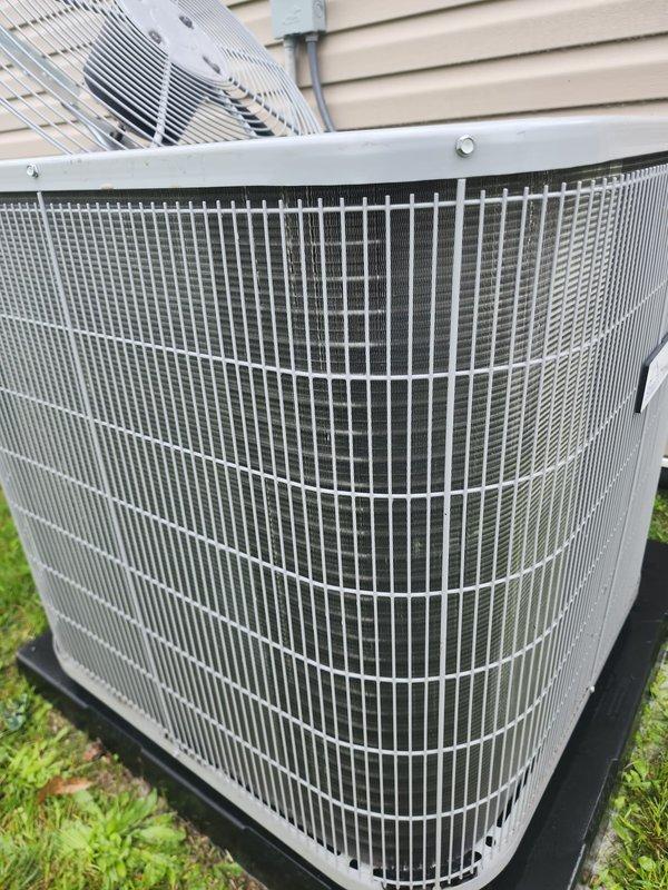Completed comprehensive cooling season maintenance inspection on residential split system air conditioning unit. Serviced outdoor condenser unit with protective grille guard and inspected indoor air handler components including condensate management system with pump assembly and drain pan. All equipment operating within normal parameters with proper drainage function confirmed.