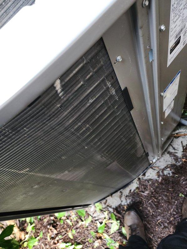 Completed annual cooling system maintenance and tune-up on properly functioning air conditioning unit. Performed comprehensive inspection of outdoor condenser unit, noting dusty condenser coils and debris accumulation around base requiring attention. Cleaned condenser fins, removed mulch and organic debris from unit perimeter to ensure proper airflow and prevent future obstruction. Inspected interior components including evaporator coil assembly, refrigerant lines, and electrical connections. Verified all copper piping connections secure with no signs of refrigerant leaks. Confirmed proper electrical wiring connections and system operation. System tested and operating within normal parameters upon completion of preventive maintenance service.