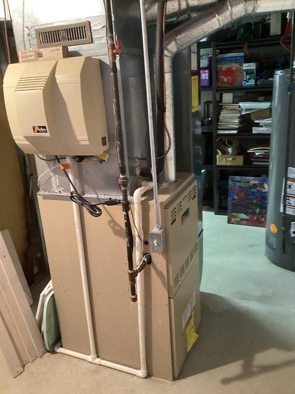Conducted comprehensive estimate appointment for complete HVAC system replacement at residential property. Evaluated original furnace and air conditioning unit, both currently operational and located in basement. Documented existing equipment configuration including beige furnace with side ventilation grates, wall-mounted humidifier with water line connection, teal-colored air handler cabinet with PVC condensate drain system, and associated ductwork and copper piping. Assessed current system layout, drainage infrastructure, and electrical components. Photographed existing equipment and installation conditions to provide accurate replacement recommendations. Both heating and cooling systems are original to the home with undetermined age, requiring full system upgrade. Provided homeowner with equipment options and installation specifications for furnace and air conditioner replacement.