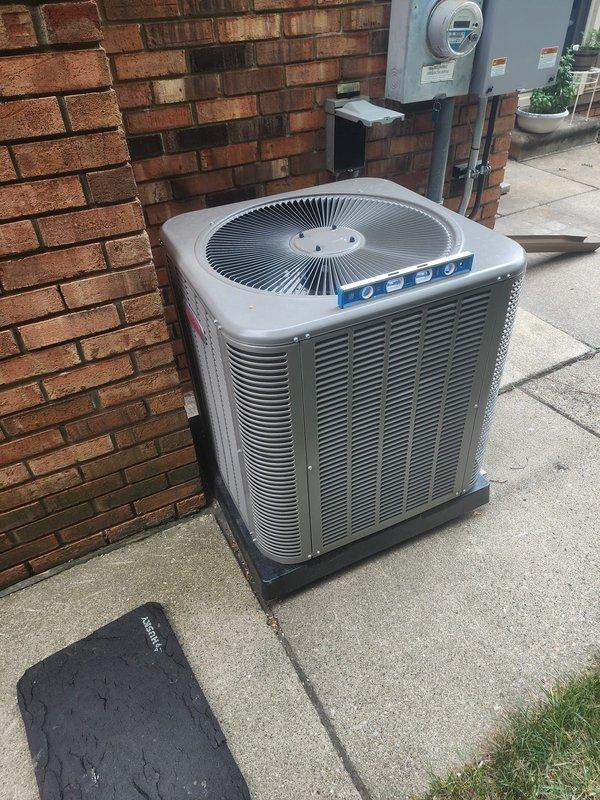 Responded to callback for outdoor AC condenser unit evaluation. Upon arrival, assessed unit for noise concerns during startup cycle and verified levelness of installation. Used precision level to check condenser positioning on mounting pad and concrete base. Unit was found to be properly leveled with no adjustment required. Conducted startup observation and monitored unit operation through multiple cycles between 8-12 timeframe as specified. No abnormal sounds or vibrations detected during compressor engagement or fan motor operation. Condenser operating within normal parameters with proper airflow through louvered panels and fan assembly functioning correctly. Installation remains secure on rubber mounting pad with adequate clearance from brick structure. Documented current condition with photos showing proper level placement and overall unit positioning for service records.