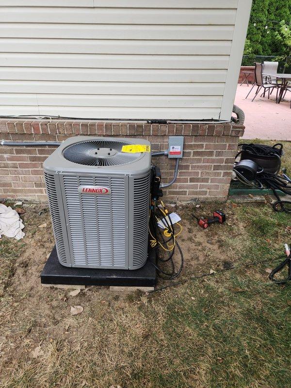 Completed full HVAC system installation including Lennox 80% AFUE downflow furnace, Lennox air conditioning condenser unit, and T6 programmable thermostat. Installed outdoor condenser on composite pad against exterior foundation with proper clearances, ran and insulated refrigerant lines, established electrical connections, and verified system pressures and operation. Inspected and confirmed crawl space condensate drain line meets current code requirements per sales specifications, ensuring proper pitch and termination for efficient moisture removal.