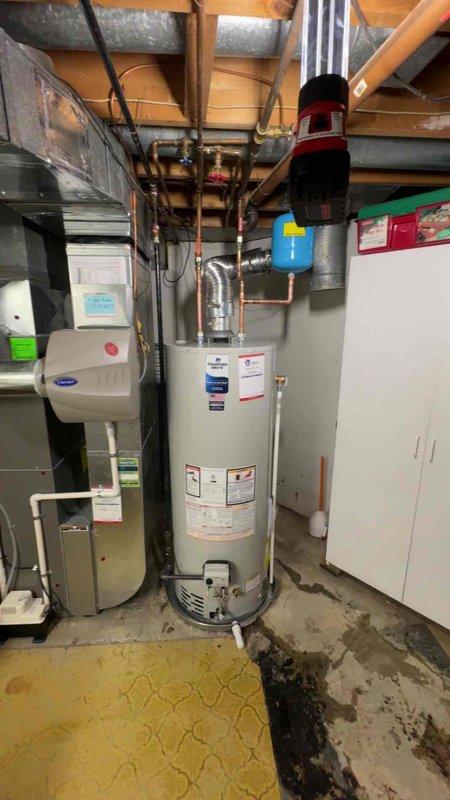 Completed installation of 50-gallon residential tanked water heater in basement mechanical room. Installed new unit with proper copper piping connections, expansion tank, pressure relief valve with discharge piping, and shut-off valves per code requirements. All connections were pressure tested and inspected for proper operation before completion.