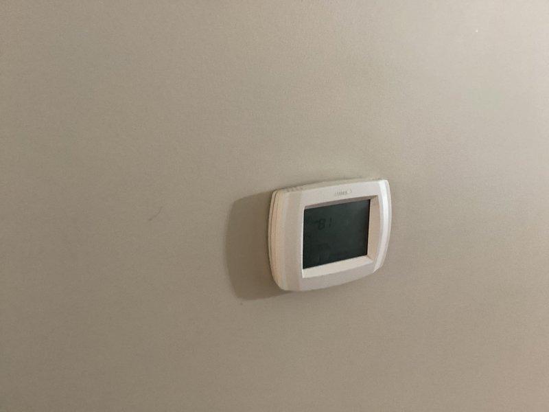 Completed installation of Lennox air conditioning system including outdoor condensing unit, indoor air handler, refrigerant line set, condensate drainage, and electrical connections. Installed new digital programmable thermostat and verified proper system operation with successful startup and temperature control functionality.