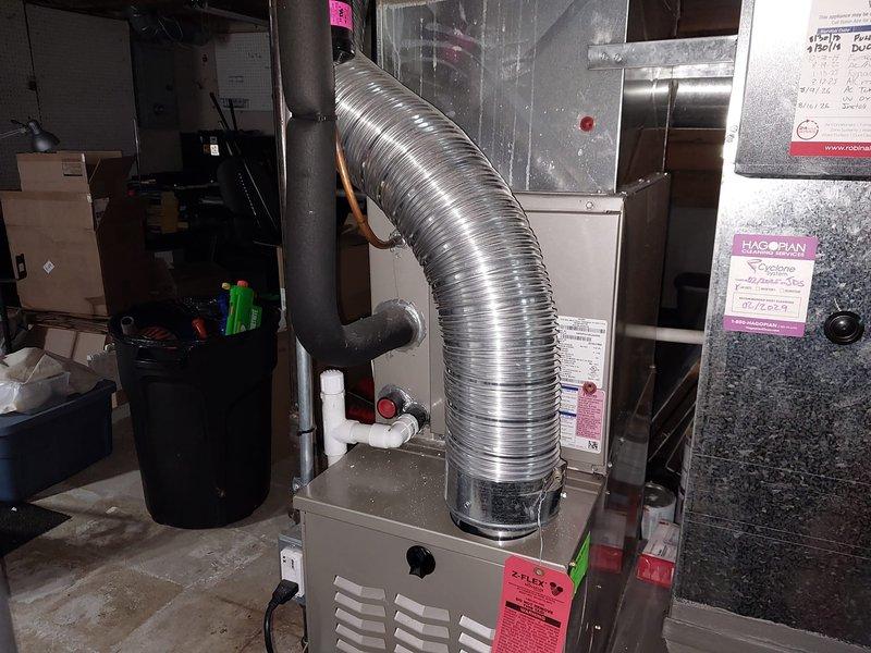 Responded to follow-up service call for system not cooling, related to possible recall issue from previous visit. Upon inspection, verified residential forced air HVAC system installation in basement utility area, including furnace unit with flexible ductwork connections, PVC condensate drainage, and standard air filtration. System components and installation appeared standard with no immediate deficiencies noted during visual inspection.