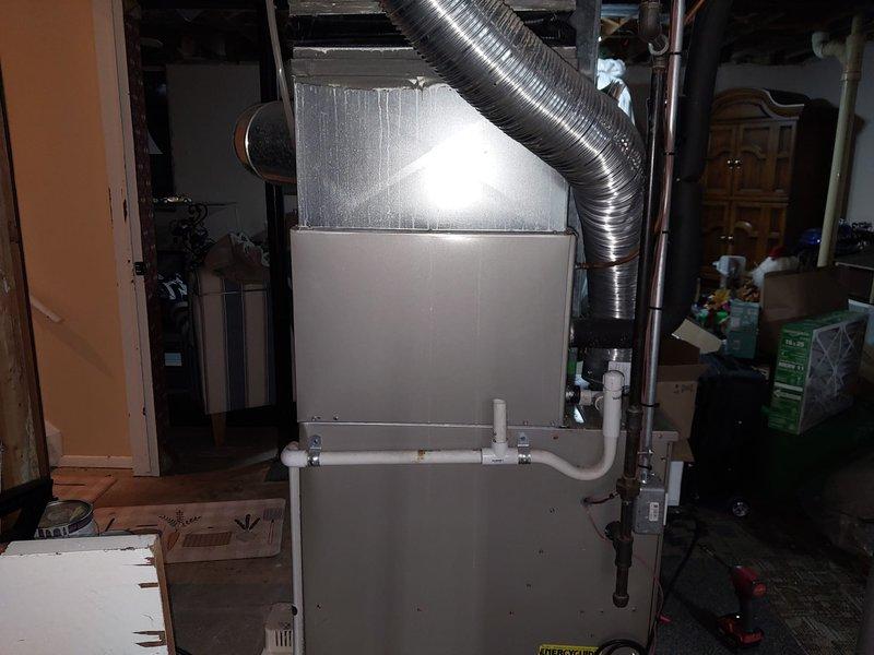 Responded to follow-up service call for system not cooling, related to possible recall issue from previous visit. Upon inspection, verified residential forced air HVAC system installation in basement utility area, including furnace unit with flexible ductwork connections, PVC condensate drainage, and standard air filtration. System components and installation appeared standard with no immediate deficiencies noted during visual inspection.