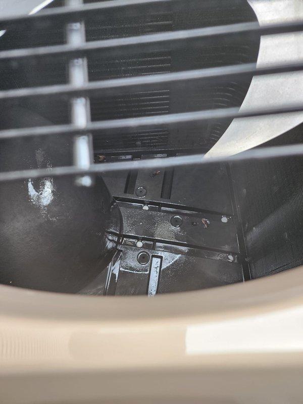 Completed routine AC maintenance on residential cooling system. Performed comprehensive inspection of outdoor condensing unit and indoor air handler components, including examination of evaporator coil fins, heat exchanger assembly, and structural mounting brackets. All internal components showed normal operational wear with minor dust accumulation typical for seasonal equipment. Verified proper airflow through louvered ventilation panels and confirmed cooling coils remain unobstructed. Unit exterior and protective grilles intact with no structural concerns noted. System operational and ready for continued service.