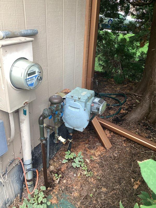 Conducted comprehensive electrical assessment for standby generator installation. Documented existing 200-amp main service panel with Cutler-Hammer/Eaton load center, photographed current circuit configuration and available breaker positions for generator interlock or transfer switch integration. Evaluated exterior utility area including meter base location, existing well pump equipment, and optimal generator placement zone. Assessed electrical service entry point, conduit pathways, and grounding requirements for automatic transfer switch installation. Provided detailed photographic documentation of panel interior circuitry and exterior utility infrastructure to support accurate material specifications and labor estimates for complete standby generator system integration.