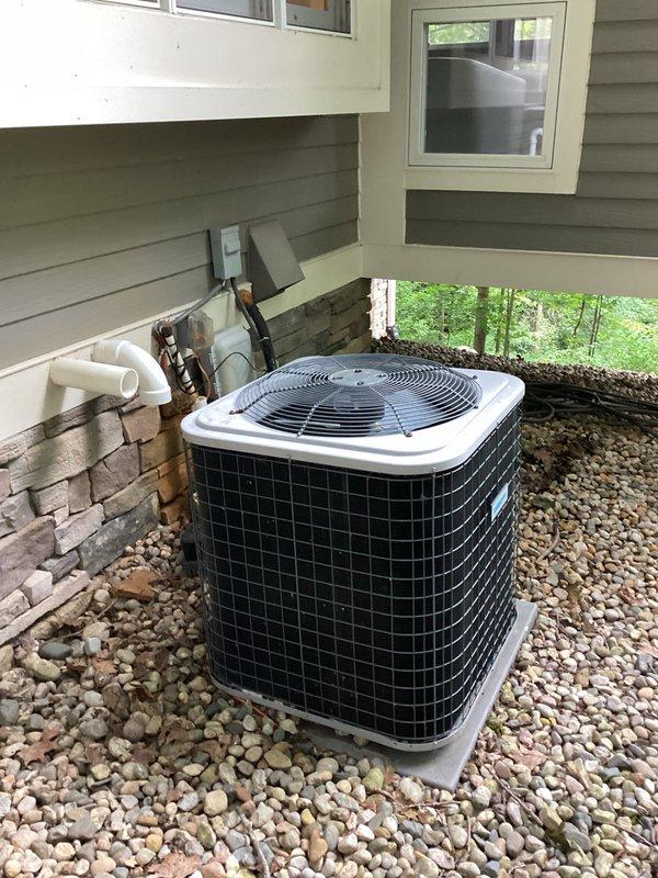Conducted comprehensive site evaluation for complete HVAC system replacement. Assessed existing outdoor condensing unit positioned on concrete pad with river rock landscaping, noting current electrical disconnect, refrigerant line set, and condensate drainage configuration. Evaluated indoor furnace and air handler installation in basement mechanical room, documenting existing ductwork connections, ventilation piping, and electrical service. Photographed equipment specifications, clearances, and access points to prepare accurate replacement estimate. Documented all system components including gas furnace, evaporator coil, outdoor condensing unit, and associated electrical and refrigerant line connections required for new equipment installation.