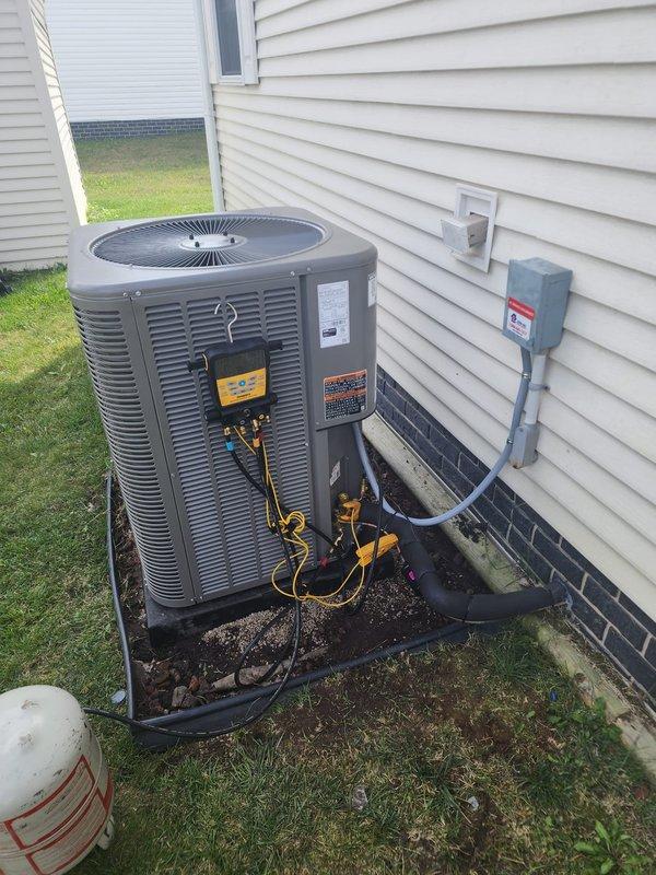 Completed installation of new Lennox air conditioning system on existing downflow furnace in mobile home application. Unit was mounted on pad against exterior wall with proper electrical disconnect installed, refrigerant lines connected and insulated, and 2-inch furnace venting replaced to meet current code requirements. System was charged, tested, and verified operational with all gauges confirming proper pressures and performance parameters.