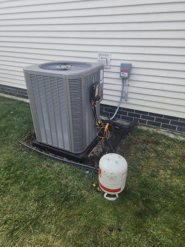 Completed installation of new Lennox air conditioning system on existing downflow furnace in mobile home application. Unit was mounted on pad against exterior wall with proper electrical disconnect installed, refrigerant lines connected and insulated, and 2-inch furnace venting replaced to meet current code requirements. System was charged, tested, and verified operational with all gauges confirming proper pressures and performance parameters.