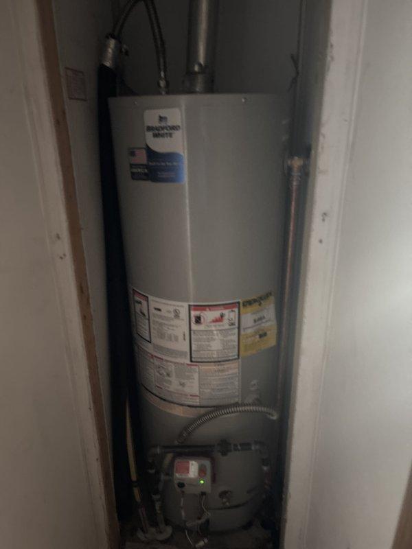 Completed installation of a 40-gallon Bradford White gas-fired water heater (Model M240X6FMRX) in residential utility closet. Connected all water supply lines, gas piping, and venting systems per manufacturer specifications and local code requirements, with unit now fully operational and ready for use.