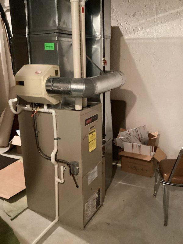 Completed furnace replacement estimate for two HVAC systems in residential basement installation. Evaluated existing beige furnace units with humidifiers and assessed ductwork configuration including metallic supply plenums and distribution systems. Provided multiple equipment options ranging from builder-grade to premium efficiency models for both systems to accommodate customer comparison with competing proposals.