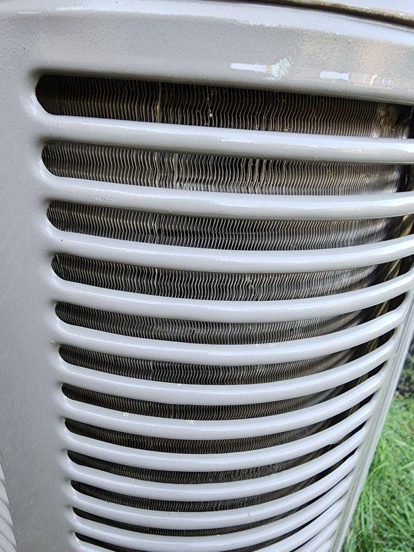 Completed comprehensive air conditioning maintenance on outdoor condensing unit. Performed standard tune-up procedures including inspection of condenser coil fins, which showed moderate dirt and debris accumulation with some surface oxidation present. Evaluated interior mechanical components and mounting hardware within the system. Unit operational and cooling properly upon completion of maintenance service.