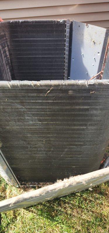 Completed scheduled preventive maintenance tune-up on residential cooling system. Inspected outdoor condensing unit and indoor evaporator coil assembly, verifying proper operation of all components including condensate pump and drain pan. Noted mineral deposits and dirt accumulation in drain pan and on condenser coils; system confirmed operational with no immediate service needs identified.