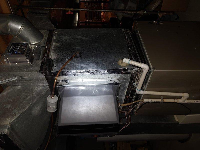 # HVAC Maintenance Visit - Critical Issues Identified

Responded to scheduled AC maintenance under prepaid service agreement. Upon inspection of indoor air handler unit located in attic space, discovered severe frost and ice accumulation on evaporator coil assembly, indicating active system malfunction. This condition prevents proper cooling operation and requires immediate attention beyond routine maintenance scope.

Documented extensive dust and debris buildup on interior surfaces of air handler cabinet, contributing to restricted airflow. Measured and photographed contaminated floor pan area showing significant particulate accumulation that can impact system efficiency and indoor air quality.

Identified potential causes for freezing coil condition including restricted airflow from dirty components, possible low refrigerant charge, or failed blower motor operation. Observed copper refrigerant lines with insulation, PVC condensate drain lines, and filter drier installation. System re