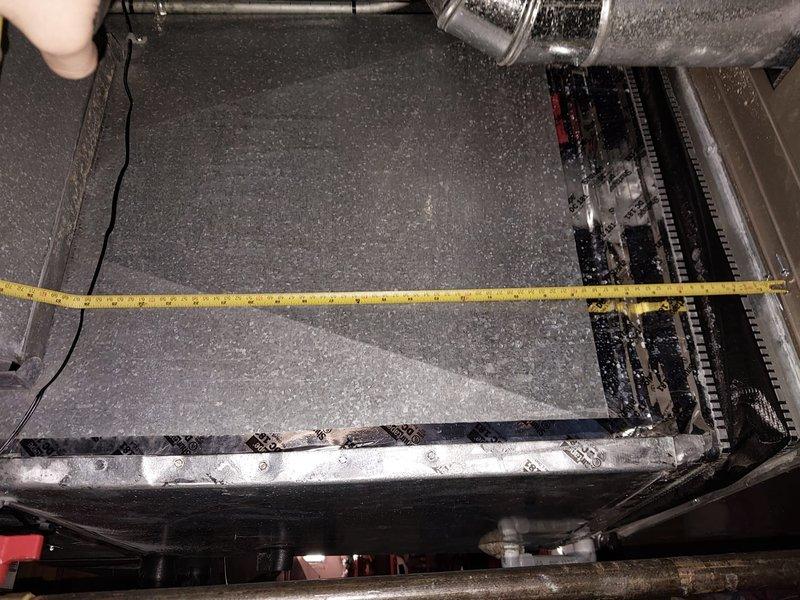 # HVAC Maintenance Visit - Critical Issues Identified

Responded to scheduled AC maintenance under prepaid service agreement. Upon inspection of indoor air handler unit located in attic space, discovered severe frost and ice accumulation on evaporator coil assembly, indicating active system malfunction. This condition prevents proper cooling operation and requires immediate attention beyond routine maintenance scope.

Documented extensive dust and debris buildup on interior surfaces of air handler cabinet, contributing to restricted airflow. Measured and photographed contaminated floor pan area showing significant particulate accumulation that can impact system efficiency and indoor air quality.

Identified potential causes for freezing coil condition including restricted airflow from dirty components, possible low refrigerant charge, or failed blower motor operation. Observed copper refrigerant lines with insulation, PVC condensate drain lines, and filter drier installation. System re