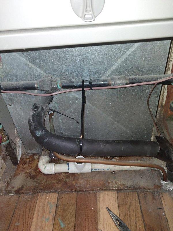 Responded to service call for reported water leak at evaporator coil. Upon arrival, performed diagnostic evaluation using digital manifold gauges to assess system pressures and temperatures across all zones. Inspected indoor air handler unit and identified moisture accumulation beneath coil assembly. Examined condensate drain pan and associated drainage components, including PVC drain lines and copper refrigerant tubing. Found evidence of water leakage consistent with drain pan compromise or condensate line blockage. Documented system conditions and component configuration with photographs for service records.