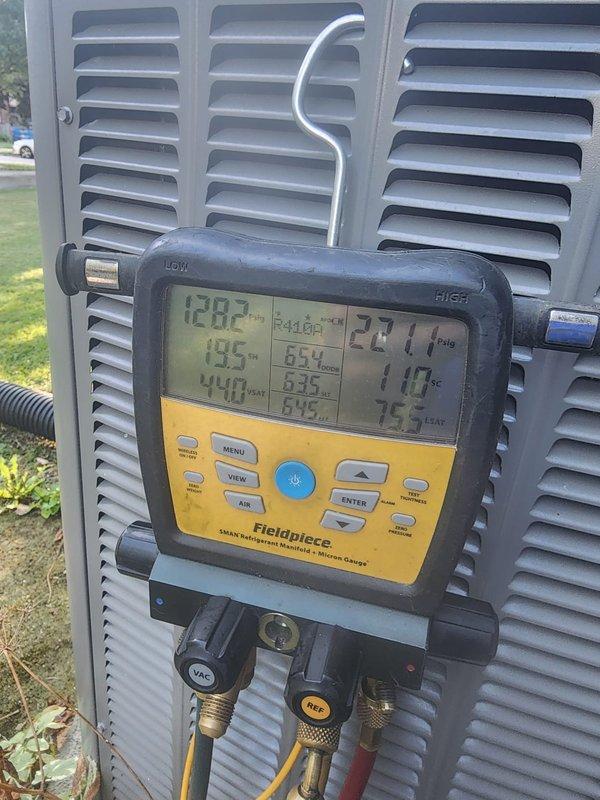 Completed scheduled AC maintenance on residential cooling system. Connected Fieldpiece diagnostic gauges to measure system pressures and temperatures, recording superheat and subcooling values to verify proper refrigerant charge and system performance. Inspected condensing unit components including dual fan assemblies, compressor, refrigerant lines, and electrical connections, noting normal condensation present on operating unit indicating proper functionality.