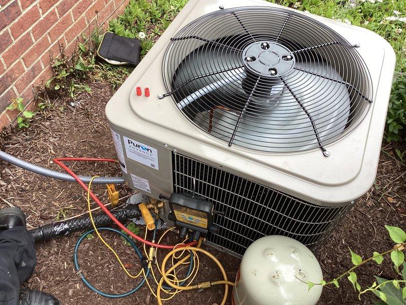 Replaced defective Duron condenser unit under warranty at residential property. Installed replacement condenser, connected refrigerant lines using brass service fittings, and performed system evacuation and charging procedures. Verified proper operation using Fieldpiece digital manifold gauges to confirm correct refrigerant pressures and temperatures. Tested fan motor operation and airflow through top-mounted circular fan assembly. Removed failed unit from site for return to shop per warranty protocol.