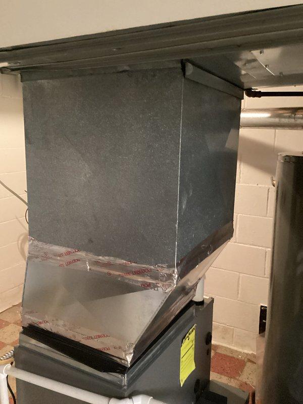 Completed estimate for air conditioning system replacement at residential property. Existing HVAC system was disconnected by another contractor during recent work, revealing advanced age and deterioration of equipment. Assessed current furnace/air handler unit, ductwork, and associated components in basement mechanical room. Documented existing system configuration including copper refrigerant lines, PVC condensate drainage, venting arrangement, and plenum connections. Noted weathered condition of metal ductwork and aging equipment requiring replacement. Photographed installation area and existing system components to provide comprehensive replacement proposal for new HVAC equipment.